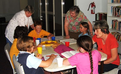Jean Reid, Angela Lester and Mary McKay help students with their homework. Photo courtesy of Warwick Uniting Church