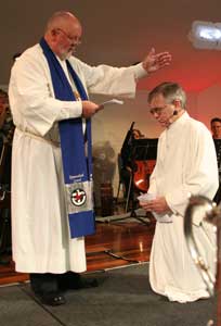 The retiring Moderator Rev Dr David Pitman prays for incoming moderator Rev Bruce Johnson 