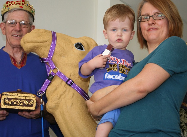 Three wise men and their camels dropped in to visit the playgroup at Indooroopilly Uniting Church on November 19. Pictured are Helen Carvolth and her son Callum, with wise man Rex Niven. Photo by Holly Jewell