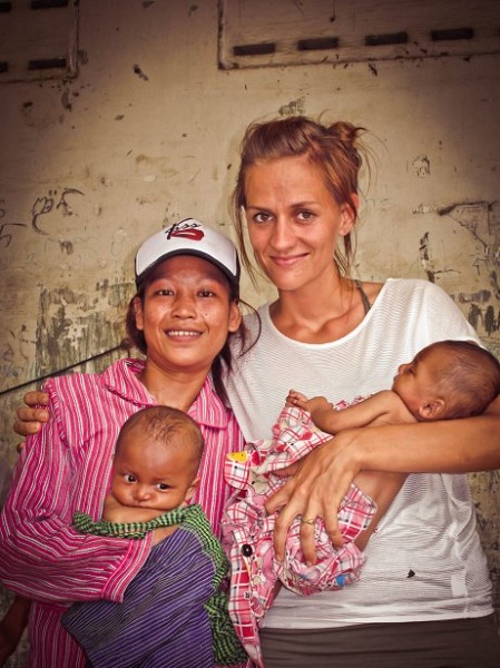 Joanna Herschell-Adair with Neang, one of the women she has supported through pregnancy, and her twins. Photo: Newlife Uniting Church