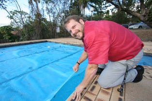 Mission Support Enterprises Business Manager Eddie Carleton inspects the Raymont Lodge pool blanket