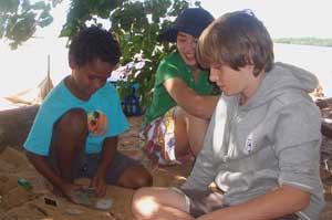 Roysten Sagigi (left) with Sherwood visitors Grace Branjerdporn and Ben Galloway at Red Beach, Mapoon. Photo by Frank Thomson