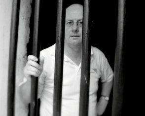 World Vision CEO Tim Costello behind bars at Elmina Castle in Ghana, the place from where hundreds of thousands of African slaves were sent to Europe and the Americas.  Photo courtesy of World Vision