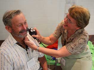 Anne Hulbert helps Eddie Gresham during the big shave off. Photo by Mardi Lumsden