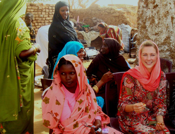 Megan McGrath in local dress, with women at Darfur