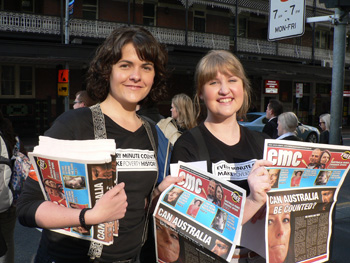 Make Poverty History volunteers Candice Caine (left) and Jade McClain help distribute copies of Every Minute Counts in Brisbane. Photo courtesy of OxfamAus