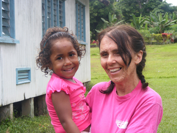 Louise Edwards with a young friend on the island of Taveuni during the Fiji Schoolies trip last year. Photo courtesy of Louise Edwards
