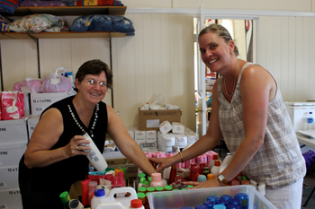 Moggill Uniting Church became the centre of the during the January flood. Church member Cheryl and community member Annabelle sort food for emergency relief. Photo by Catherine Solomon