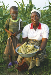 A conservation farmer and her young son in Zimbabwe. Photo by Janet Cousens/Act for Peace