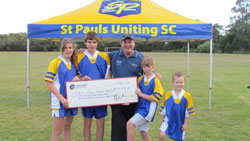 Alice Jones, Henry Jones, Hon Phil Reeves MP, and Nick Golinski with the cheque. Photo courtesy of St Pauls