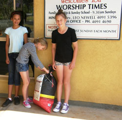 Right: Nine-year-old Michala (centre) with her contribution to the program. Friends Jesica and Talia assist. Photo by Ludij Peden 