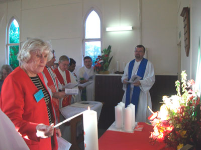 Maragret Cox lights a candle at the service to celebrate the Mt Mee Covenant. Photo by Kaye Ronalds