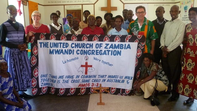 United Church of Zambia, Jerusalem Church members present Sylvia and Don Wright with a banner for South Rockhampton Uniting Church. Photo courtesy of Don Wright  