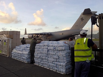 Act for Peace staff assist the Fiji government to distribute emergency relief after tropical cyclone Evan. Photo: Anthony Blake/Act for Peace