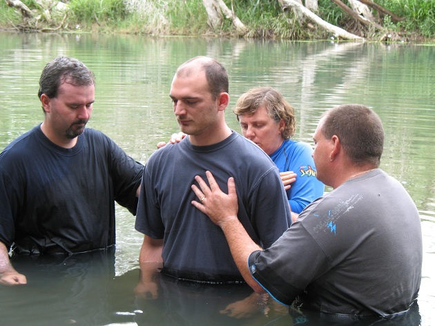 Baptism at Mt Louisa House of Praise church camp; (L to R) Ben Neideck, Brian Christie, Rev Anne Harley, Joel Mackereth. Photo: Steve Hawes