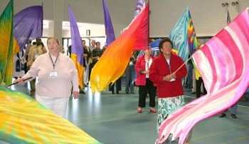 Worshippers wave banners during service of celebration. Photo: Holly Jewell