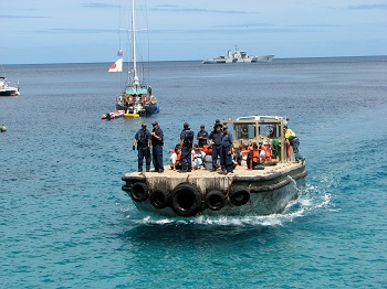 Asylum seekers escorted ashore Photo: DIAC images, Creative Commons