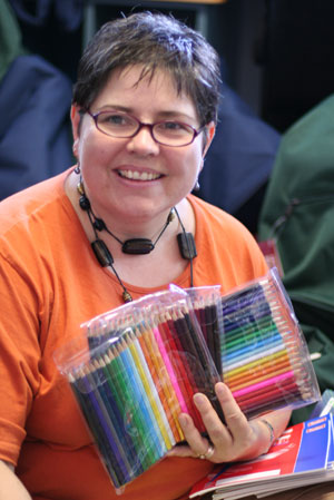 Heather den Houting sorts piles of coloured pencils ready for the backpacks. Photo by Mardi Lumsden