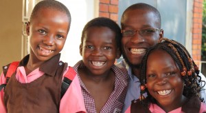Allan, centre, with Pastor Peter Sewakiryanga and other children saved from child sacrifice by Kyampisi Childcare Ministries