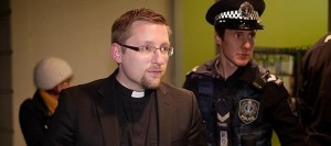 Reverend John Hughes, of Brougham Place Uniting Church, is arrested for trespassing at the Mt Barker electoral office of Federal MP Jamie Briggs after staging a sit-in to protest children being held in immigration detention centres.