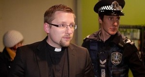 Reverend John Hughes, of Brougham Place Uniting Church, is arrested for trespassing at the Mt Barker electoral office of Federal MP Jamie Briggs after staging a sit-in to protest children being held in immigration detention centres.