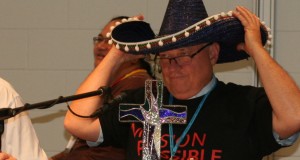 Rev David Baker wears a sombrero to promote Trinity College Queensland's new OLE learning system at the 31st Synod in Session.