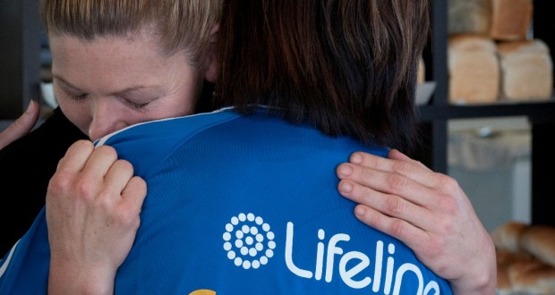 A Lifeline representative hugging a member of the public. Photo by UnitingCare.