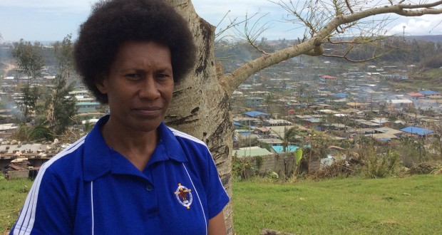 Martha, UnitingWorld gender project officer, standing in front of a devastated Port Vila. Photo by UnitingWorld.