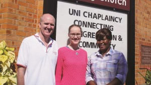 Rev Peter Lockhart (M) with Kate Brazier (R) and Lwanda Kahongo (L) at St Lucia Uniting Church. Photo by Ashley Thompson.