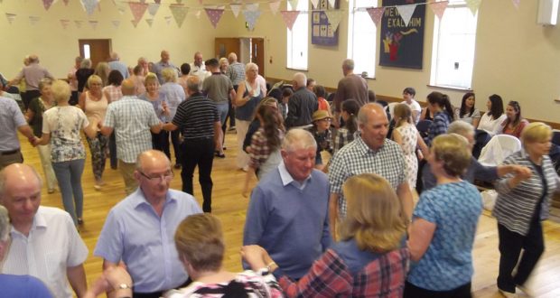 Attendees get into the swing of things at a fundraising barn dance in Greenisland, Northern Ireland. Photo by Eric Lawson.