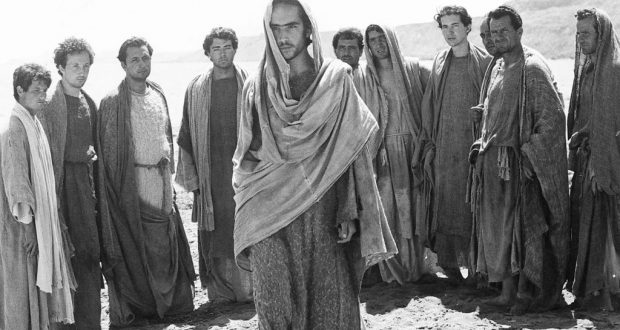 Enrique Irazoqui (centre) stars in Pasolini’s The Gospel According to Matthew. A photo of men in robes is shown. Photo property of Eureka Entertainment Limited.