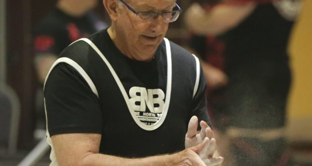 Iven prepares for competition at the Australian National Powerlifting Championships by dusting his hands with chalk. Photo by Peter Hewett.