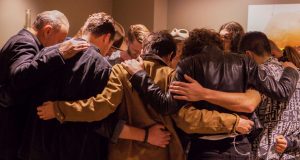 Members of Hillsong United gather to pray before a concert. Photo: Pure Flix