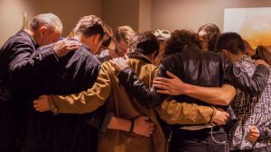 Members of Hillsong United gather to pray before a concert. Photo: Pure Flix