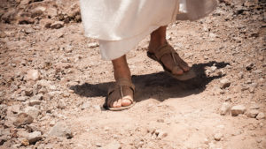 Feet on dusty road